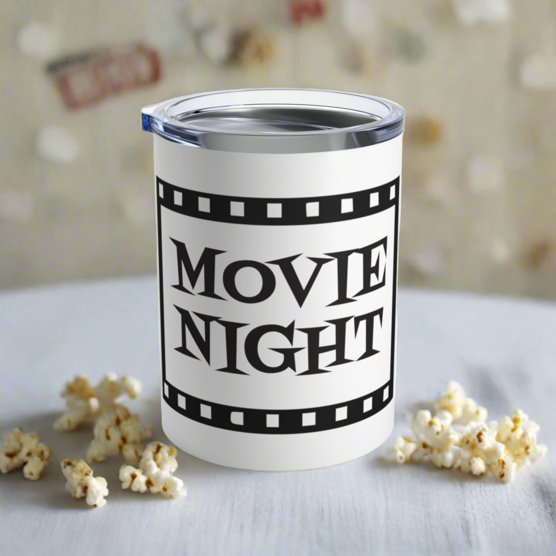 This 10 ounce stainless steel glossy tumbler has a black and white theme with retro atomic era lettering that says Movie Night with a film strip around the lettering.