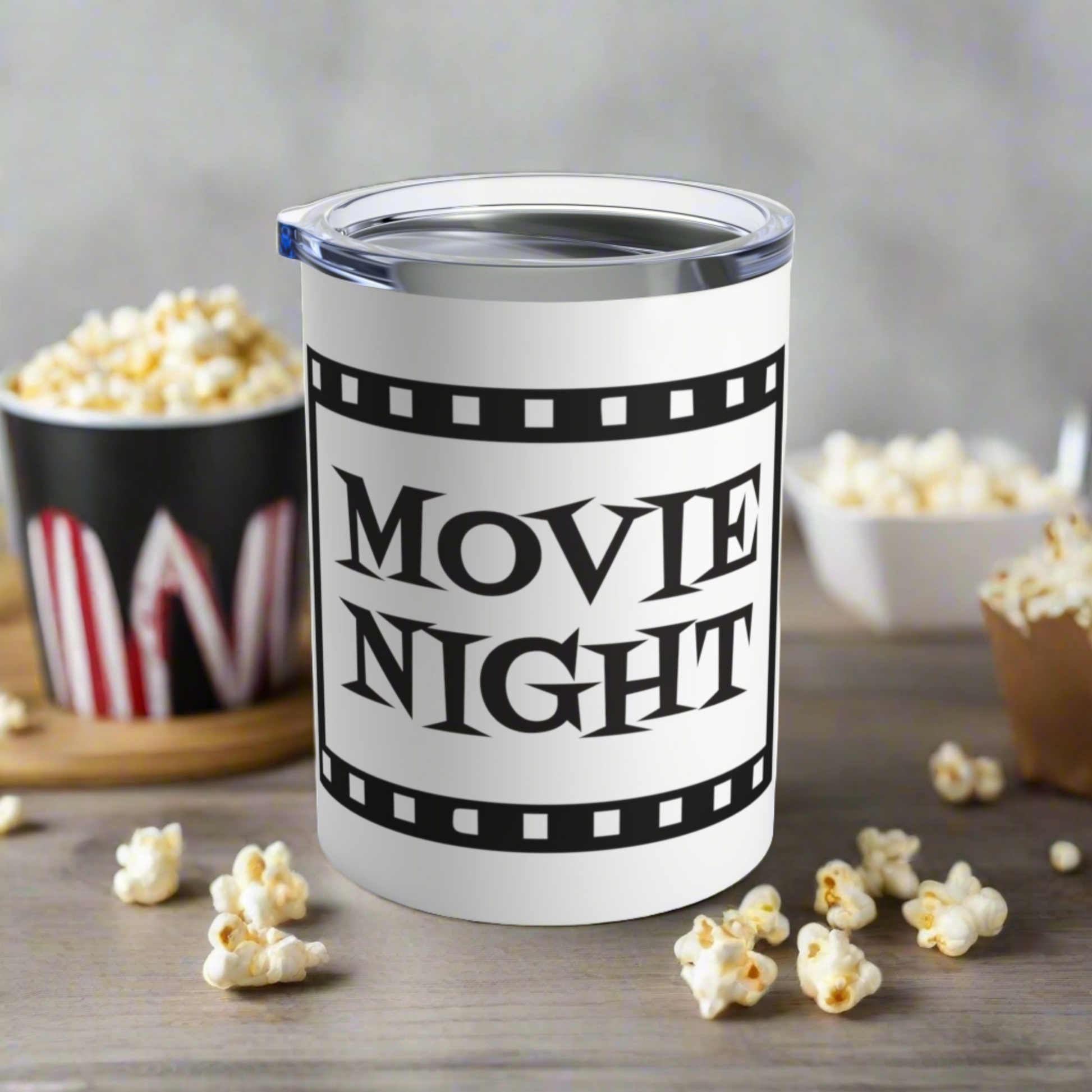 This 10 ounce stainless steel glossy tumbler has a black and white theme with retro atomic era lettering that says Movie Night with a film strip around the lettering.