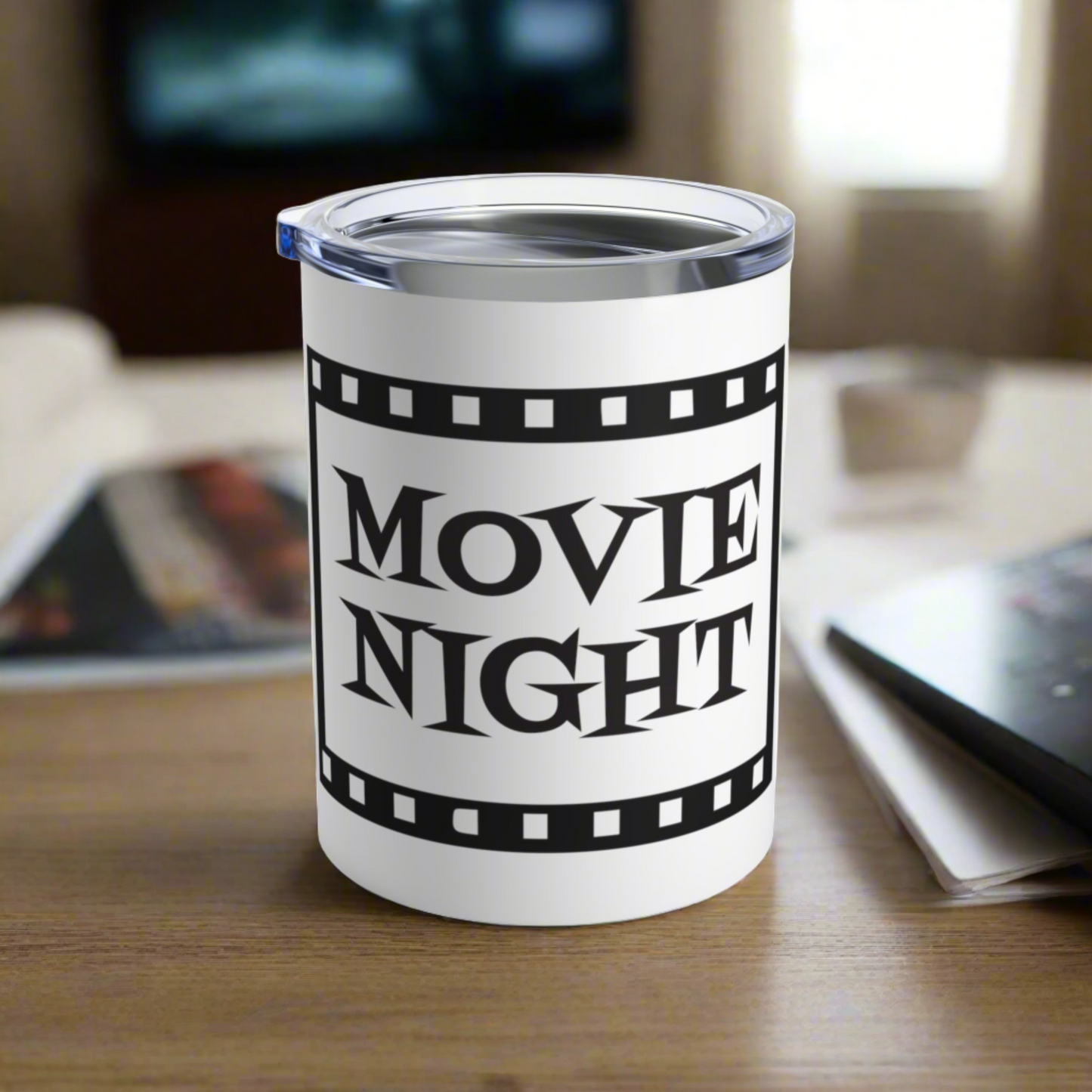 This 10 ounce stainless steel glossy tumbler has a black and white theme with retro atomic era lettering that says Movie Night with a film strip around the lettering.