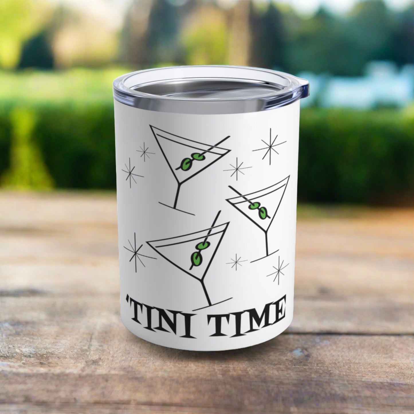 This 10 ounce white stainless steel tumbler features three martini glasses with green olives on toothpicks surrounded by stars and at the bottom the words say Tini Time in Atomic Retro Style lettering.