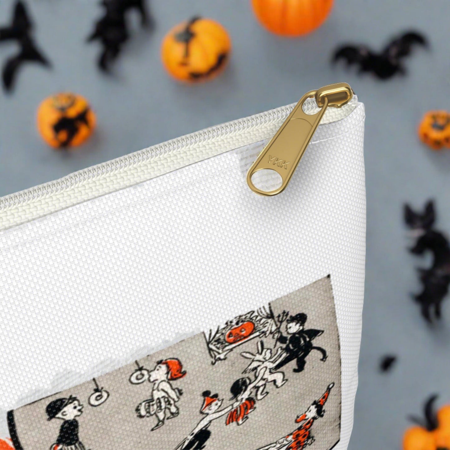 Halloween pouch travel bag. This white bag has a white zipper and gold puller. The design is a retro print of a Halloween Party Board game with adorable nostalgic artwork.