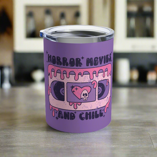 This 10 ounce purple stainless steel travel mug features distressed retro artwork that says Horror Movies and Chill. It features a pink VHS tape with a cute heart and skeleton in the middle.