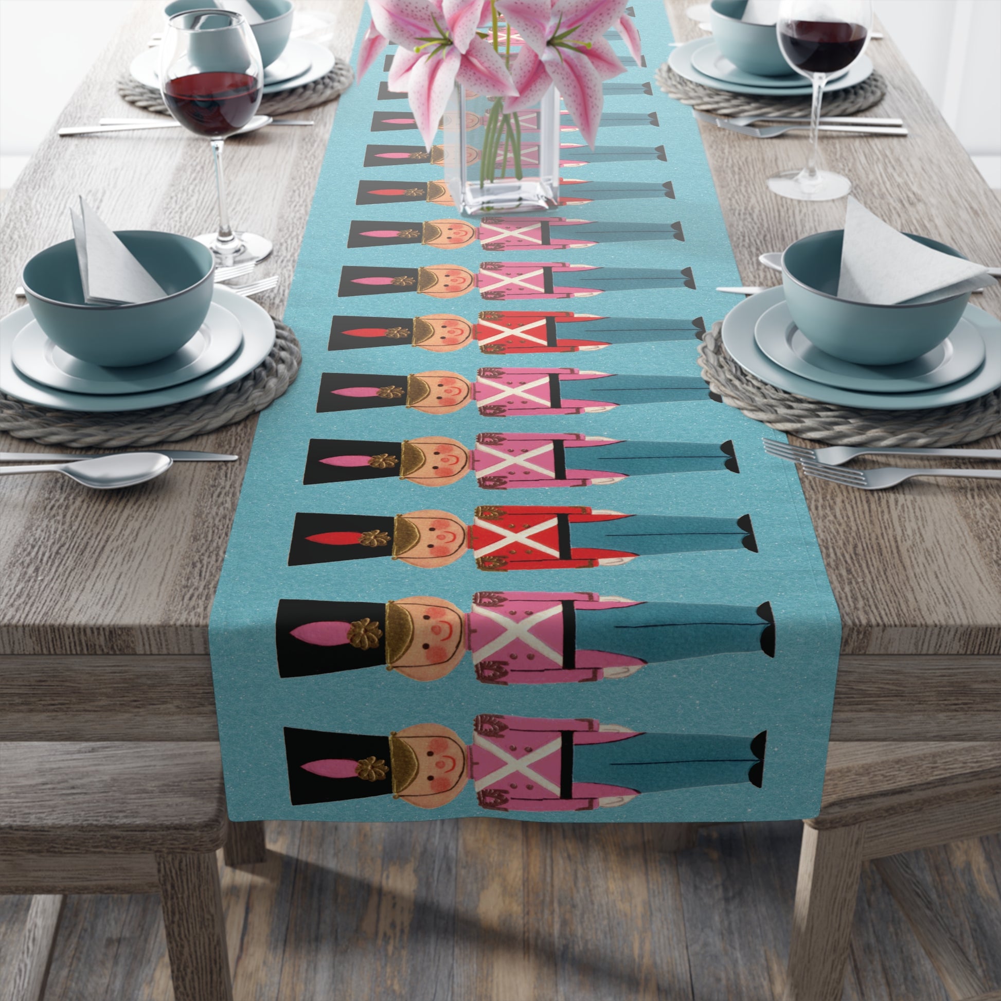 This blue fabric table runner features a Midcentury Christmas illustration of toy soldiers in red and white tops with a blue background. The blue is a retro felt background that shows little white sparkles.