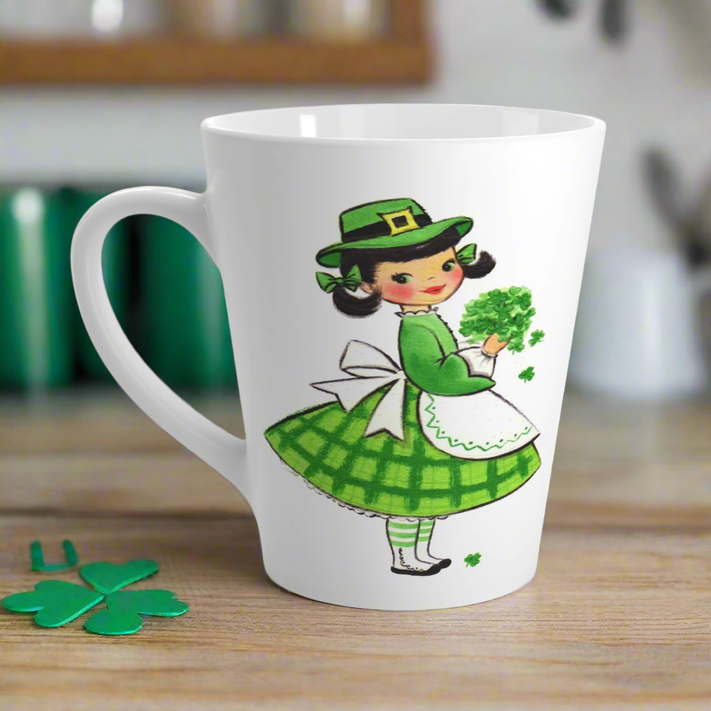 This ceramic glossy latte coffee mug features a midcentury St. Patrick's Day illustration of an adorable girl dresed in green holding a bouquet of shamrocks.