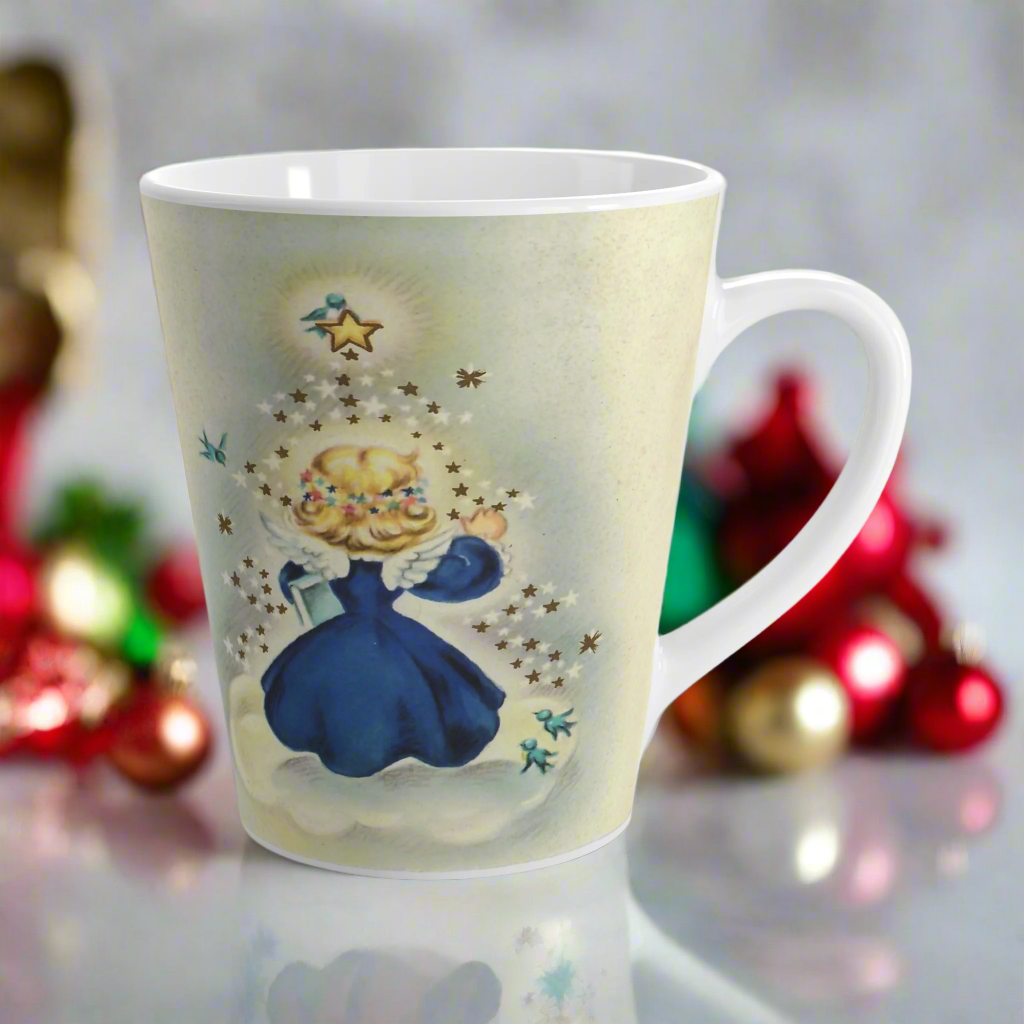 This ceramic glossy latte mug features an angel dressed in blue standing on a cloud. Her back is to us and you can see her wings. She is standing under a yellow star and bluebird. There are smaller white and blue stars and bluebirds surrounding her.