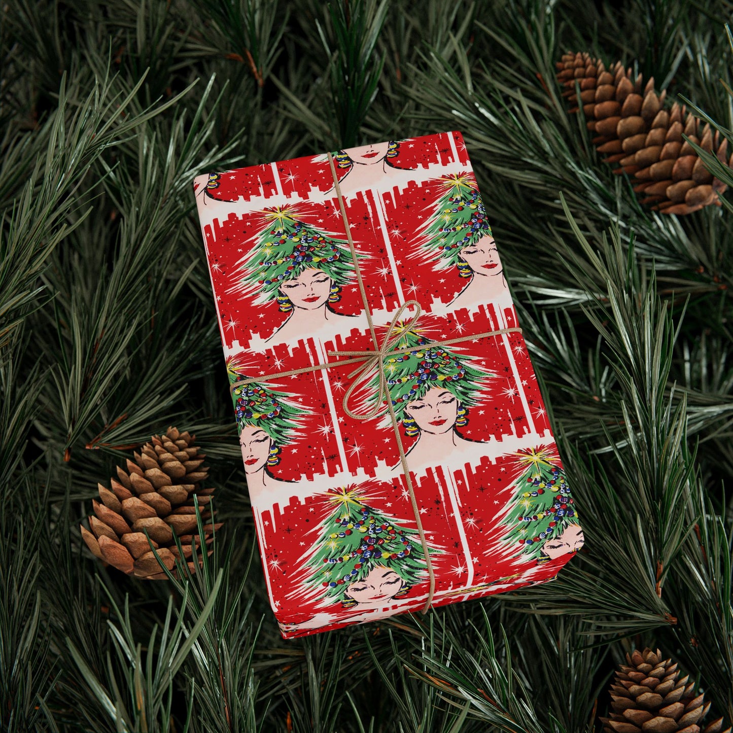 This festive Christmas gift wrap features a retro Midcenturyprint of a woman wearing a Christmas tree hat with a red background and black and white starbursts.