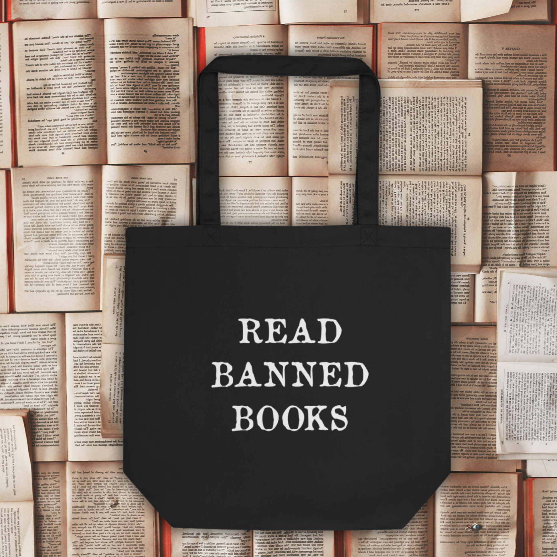 This large black eco cotton tote bag features white lettering that says in all capital letters Read Banned Books.