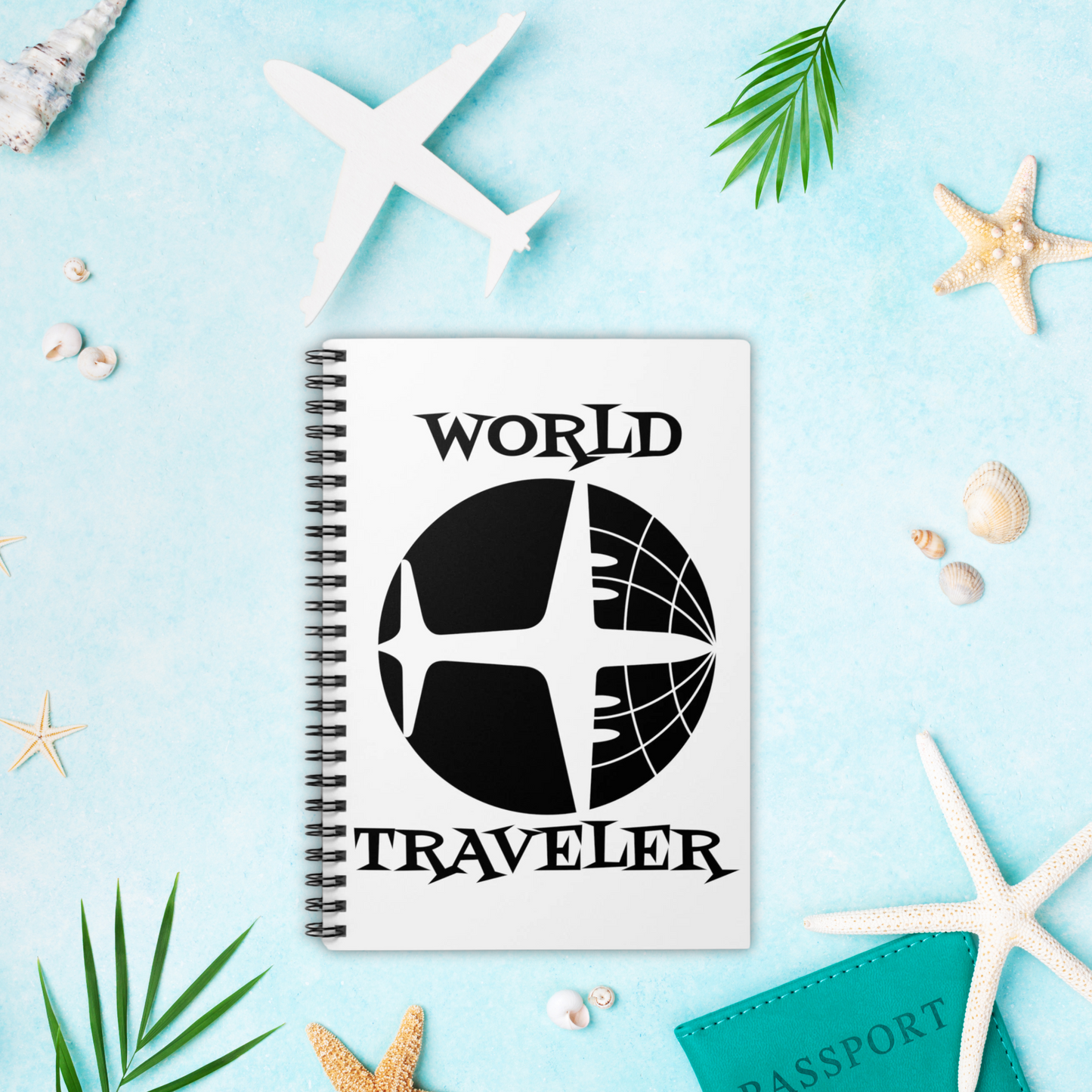 This white spiral journal features a retro print of an airplane and the globe with atomic era lettering that says World Traveler.