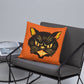 This orange square pillow features a retro midcentury Halloween print of a Black Cat with orange and yellow eyes, ears, nose, whiskers and mouth.