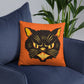 This orange square pillow features a retro midcentury Halloween print of a Black Cat with orange and yellow eyes, ears, nose, whiskers and mouth.