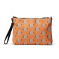 This orange crossbody purse features a skeleton hand making a peace sign surrounded by bats, flowers and peace signs.