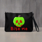 This black crossbody purse features a large red apple dipped in green poison with the words Bite Me underneath and the back is a small size in a patterned print.