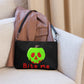 This black crossbody purse features a large red apple dipped in green poison with the words Bite Me underneath and the back is a small size in a patterned print.