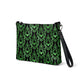 This black crossbody shoulder bag converts into a large wristlet clutch features a retro wallpaper print of green bats and swirls.