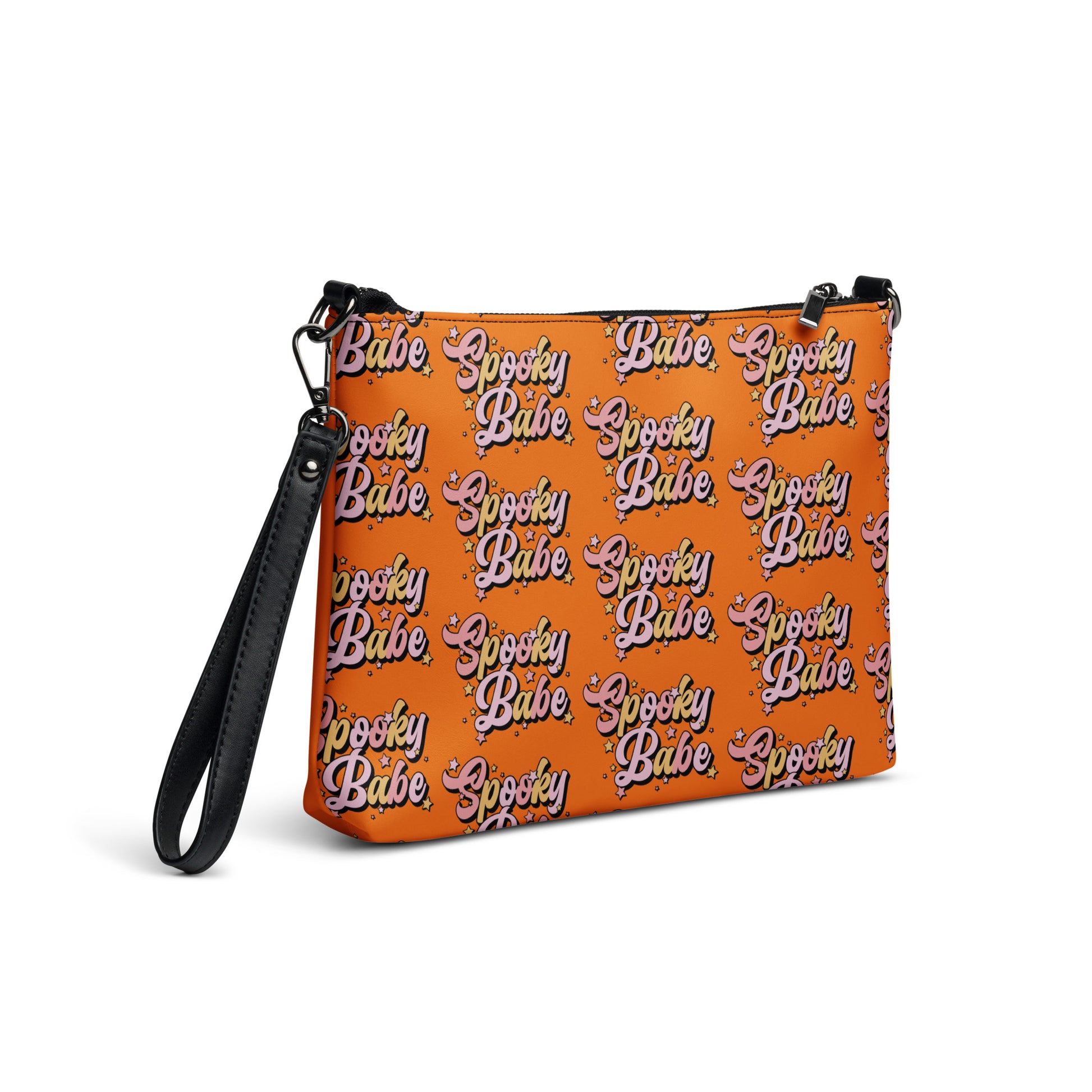 This orange crossbody purse features a retro Barbie style type of lettering that says Spooky Babe in fall pastel colors with stars.