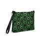 This black crossbody shoulder bag converts into a large wristlet clutch features a retro wallpaper print of green bats and swirls.