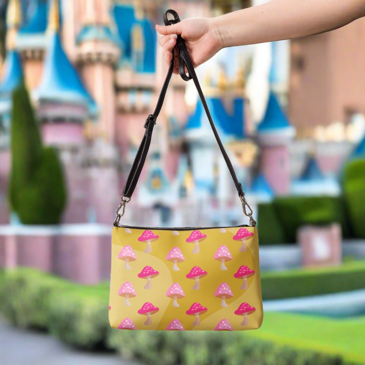 This yellow crossbody purse features the cute smoking caterpillar on one side and pink mushrooms on the other. It's a shoulder bag that converts into an oversized wristlet clutch.