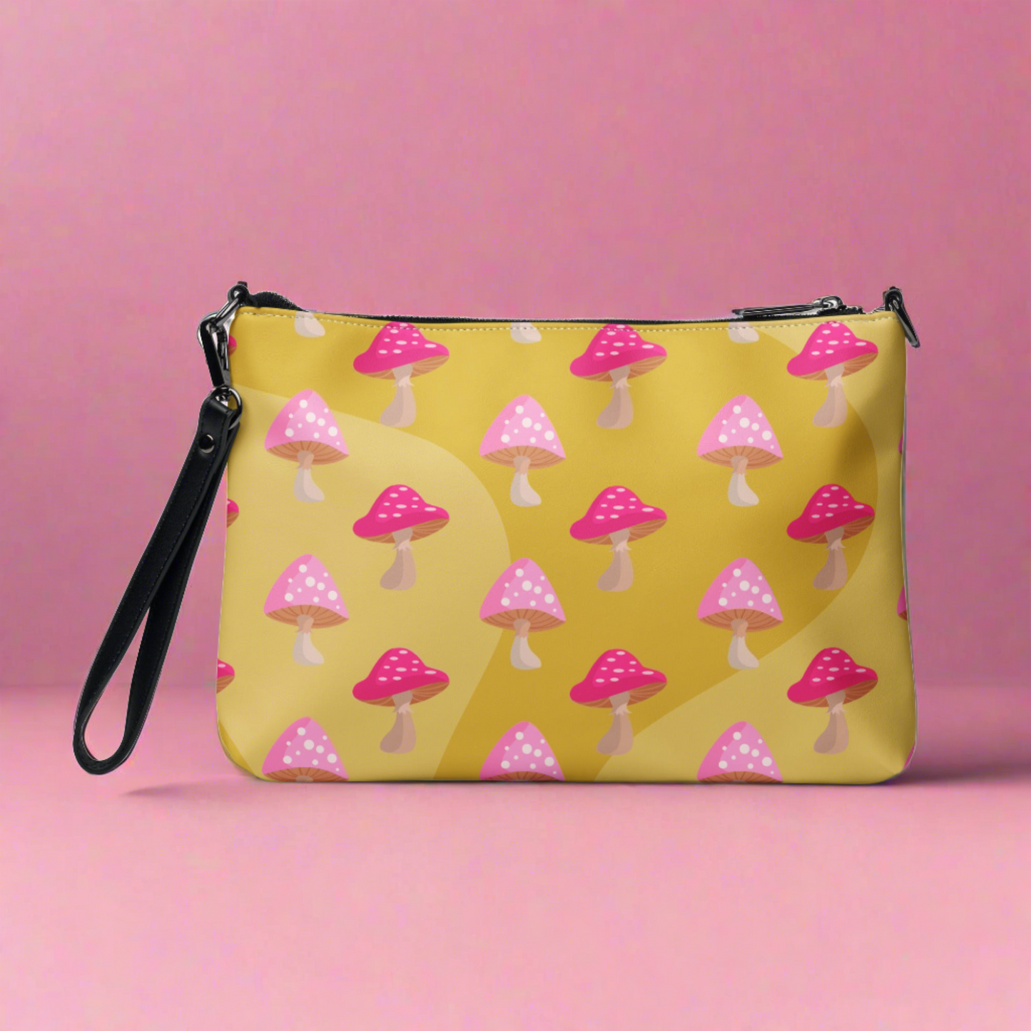 This yellow crossbody purse features the cute smoking caterpillar on one side and pink mushrooms on the other. It's a shoulder bag that converts into an oversized wristlet clutch.