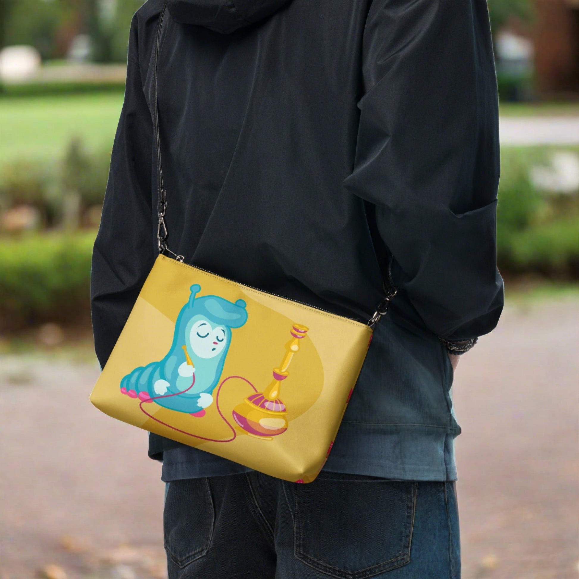 This yellow crossbody purse features the cute smoking caterpillar on one side and pink mushrooms on the other. It's a shoulder bag that converts into an oversized wristlet clutch.