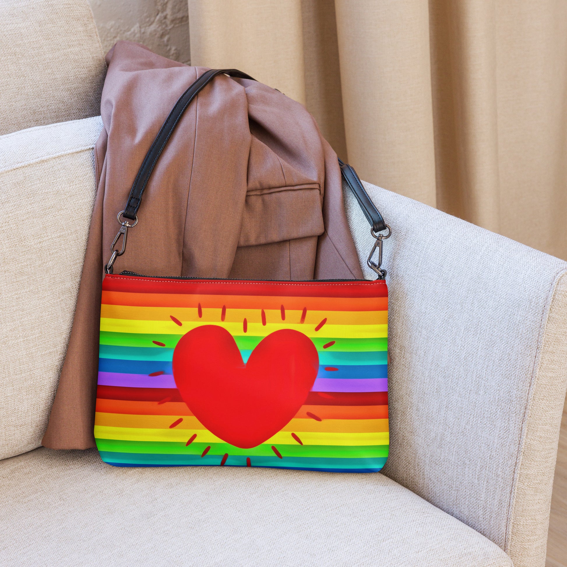 This shoulder crossbody purse converts to a large wristlet clutch. It features horizontal rainbow stripes with a large red heart in the center.