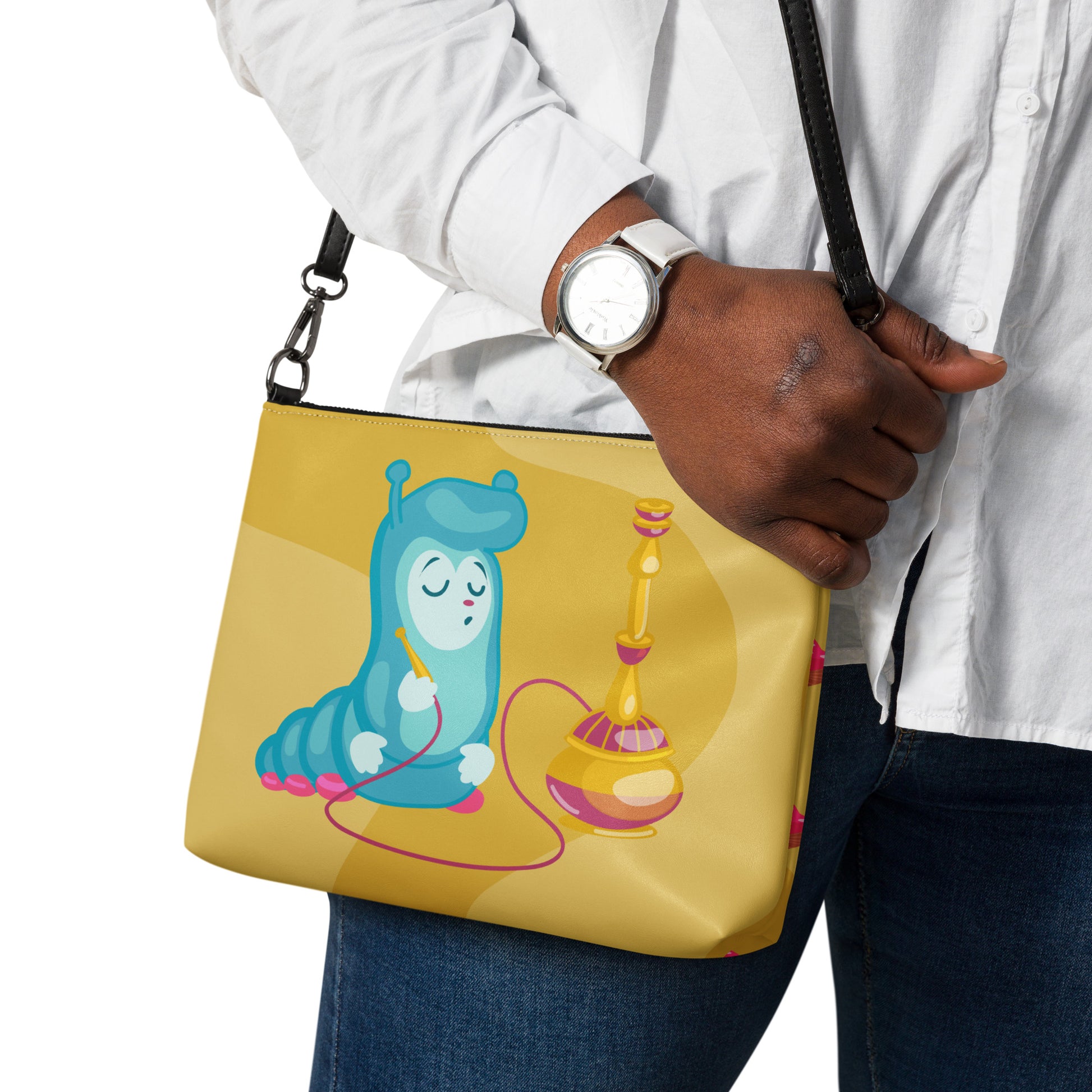 This yellow crossbody purse features the cute smoking caterpillar on one side and pink mushrooms on the other. It's a shoulder bag that converts into an oversized wristlet clutch.