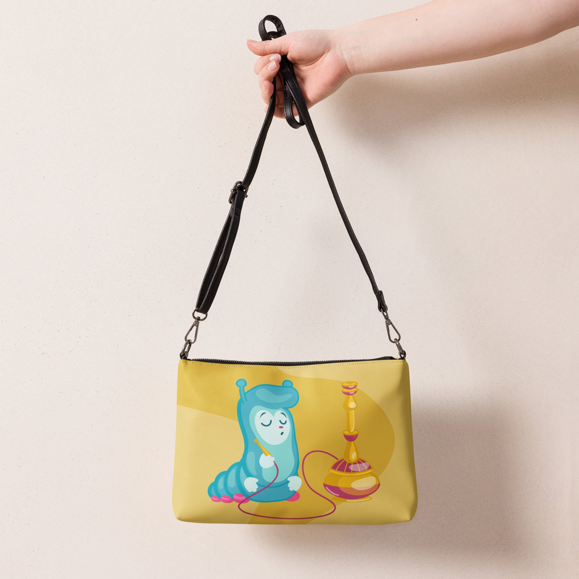 This yellow crossbody purse features the cute smoking caterpillar on one side and pink mushrooms on the other. It's a shoulder bag that converts into an oversized wristlet clutch.