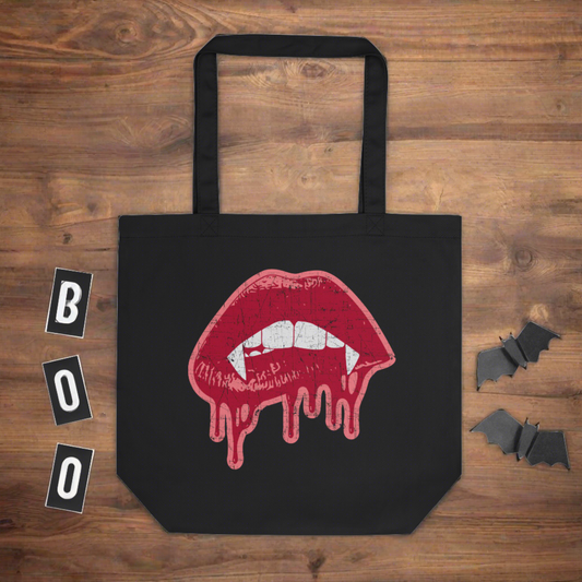 This largo eco cotton tote bag features red vampire lips and fangs dripping in blood outlined in pink.