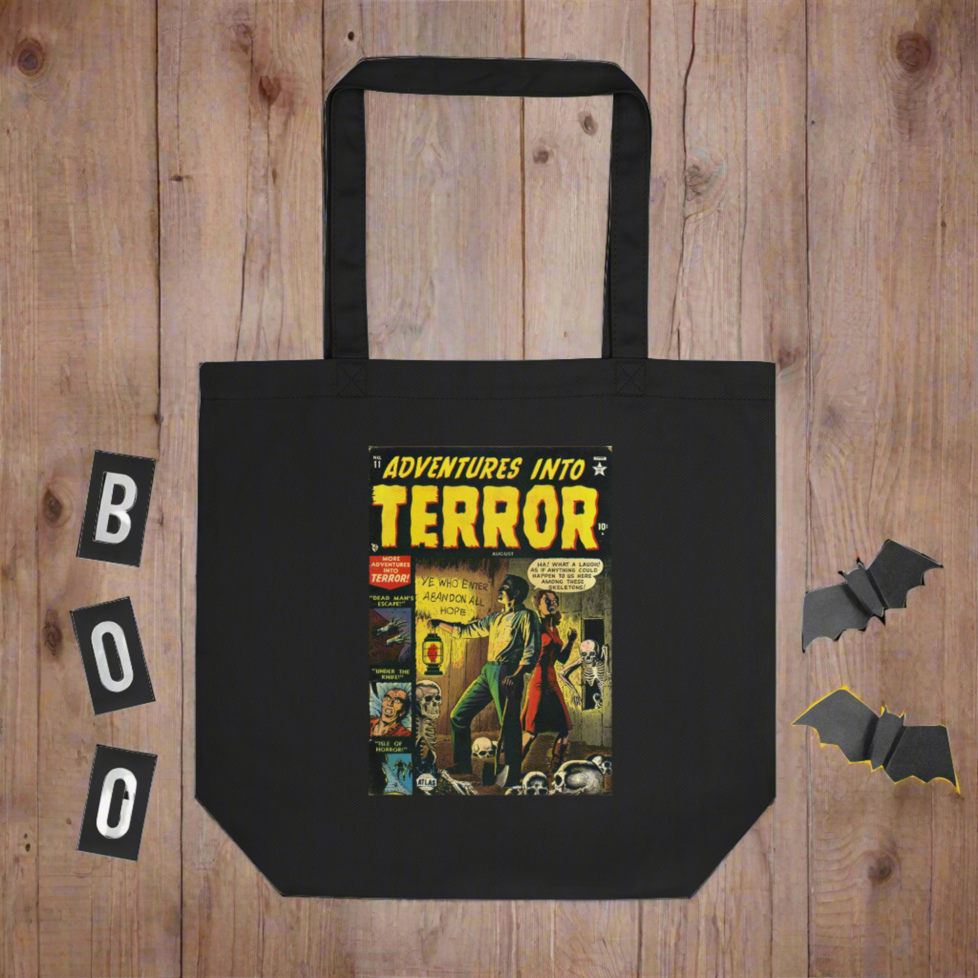 This largo eco cotton black tote bag features a vintage comic book cover titled Adventures Into Terror. It features a couple with a lantern surrounded by skeletons.