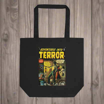 This largo eco cotton black tote bag features a vintage comic book cover titled Adventures Into Terror. It features a couple with a lantern surrounded by skeletons.