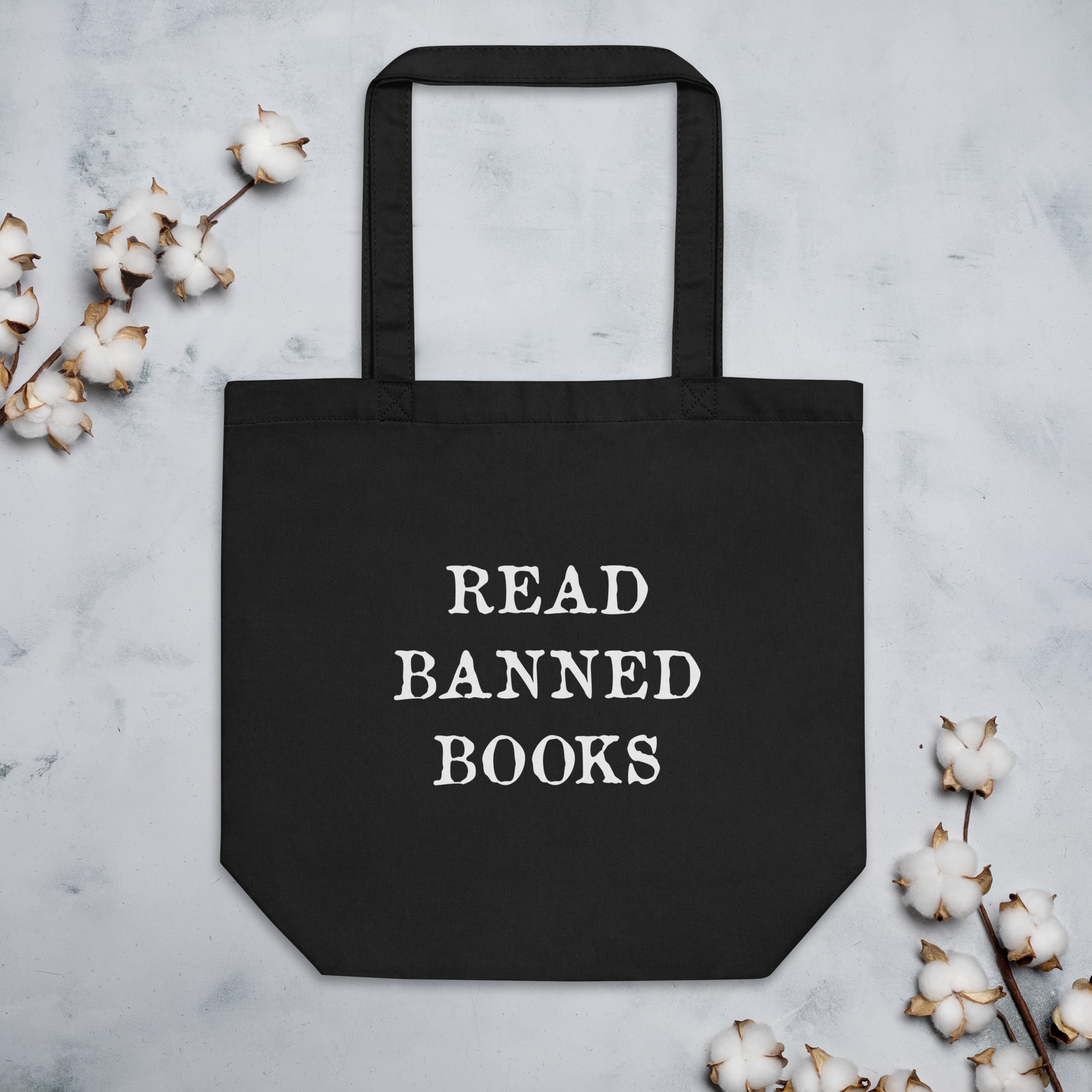 This large black eco cotton tote bag features white lettering that says in all capital letters Read Banned Books.