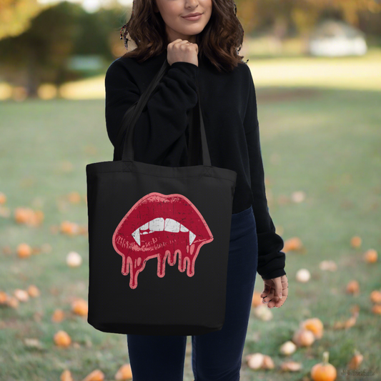 This largo eco cotton tote bag features red vampire lips and fangs dripping in blood outlined in pink.