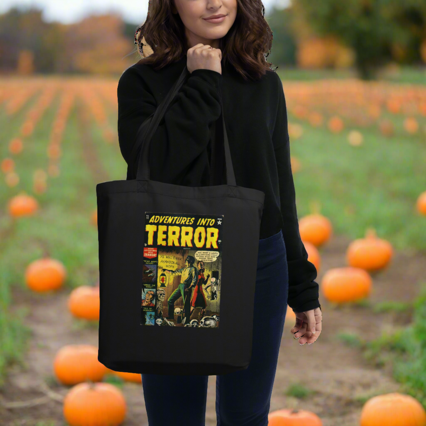 This largo eco cotton black tote bag features a vintage comic book cover titled Adventures Into Terror. It features a couple with a lantern surrounded by skeletons.