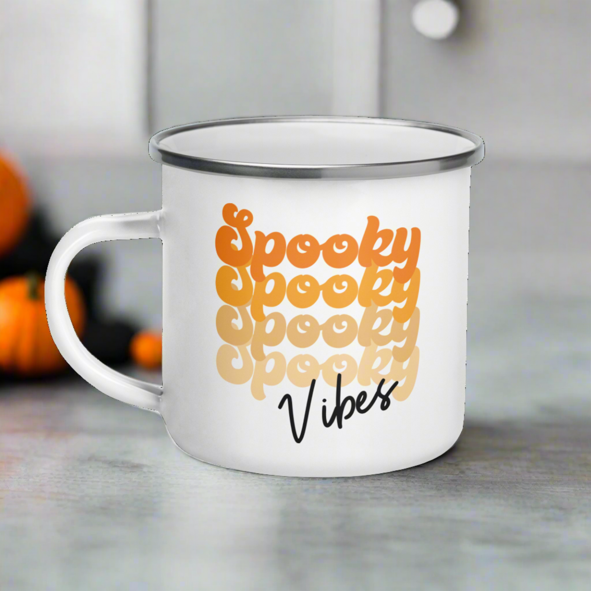 This 10 ounce enamel camping mug features a retro style font that says Spooky four times in various shades of orange with vibes in black.