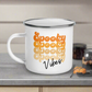 This 10 ounce enamel camping mug features a retro style font that says Spooky four times in various shades of orange with vibes in black.