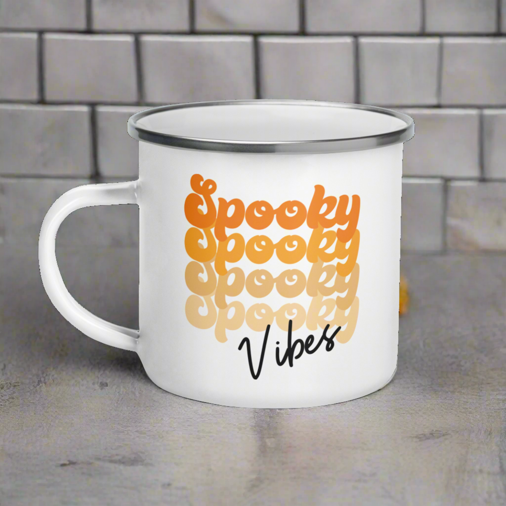 This 10 ounce enamel camping mug features a retro style font that says Spooky four times in various shades of orange with vibes in black.