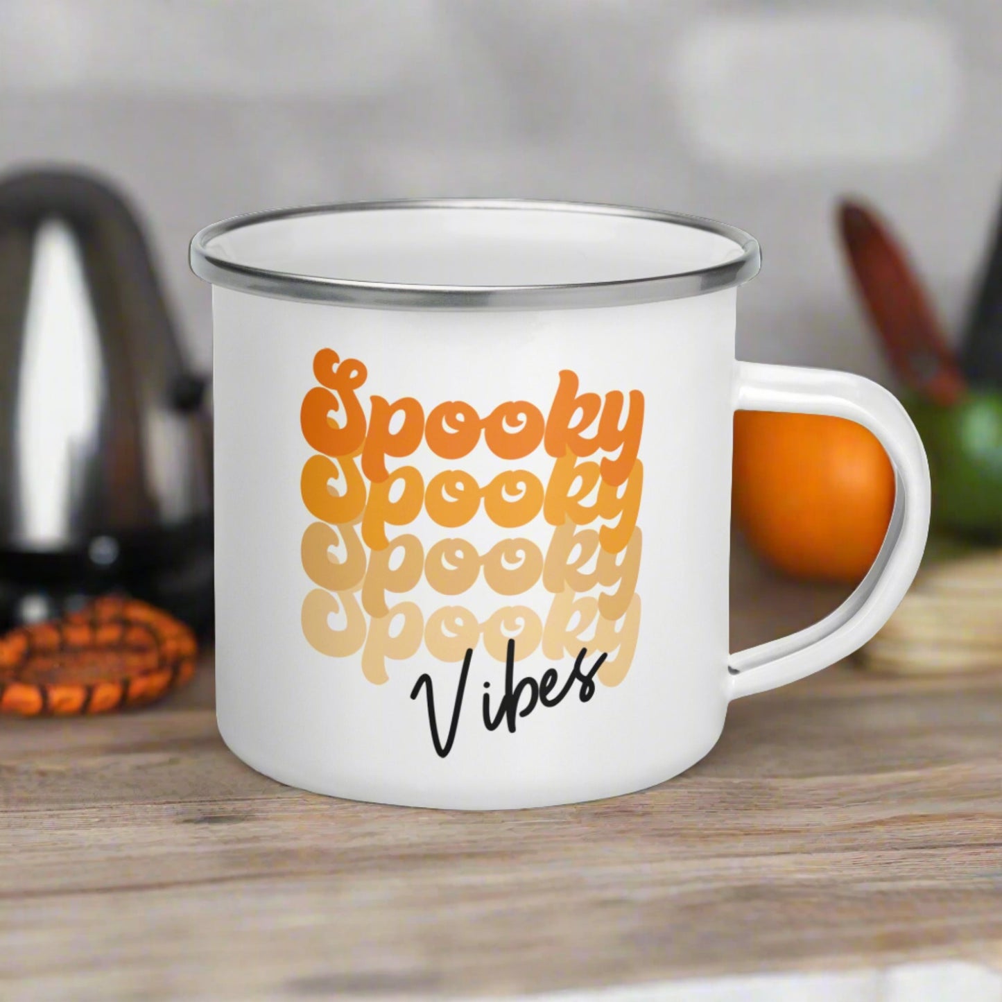 This 10 ounce enamel camping mug features a retro style font that says Spooky four times in various shades of orange with vibes in black.