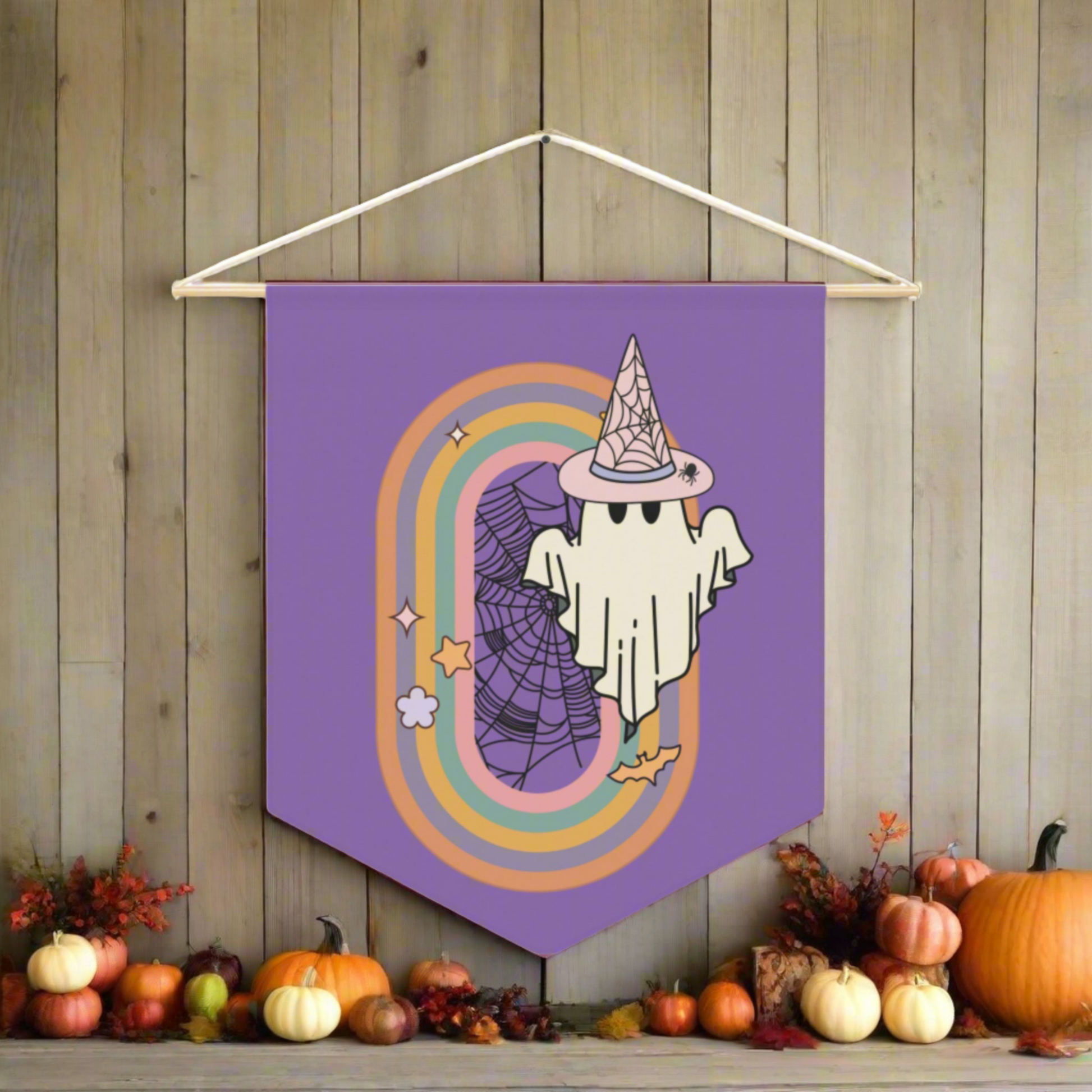 This purple pennant banner flag wall hanging features a retro boho pastel gothic style print of a ghost wearing a witch hat with a rainbow and spider web.