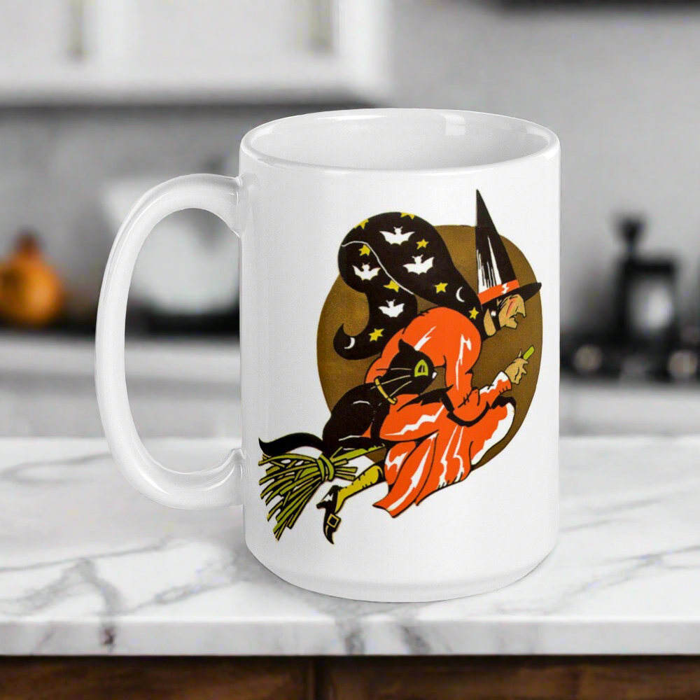 This ceramic glossy coffee mug features a retro vintage Halloween print of a witch flying on her broom with her black cat and a gold moon in the background.