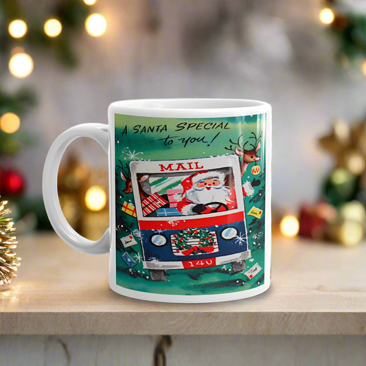 This ceramic glossy coffee mug features a midcentury retro Christmas illustration that says A Santa Special to you and features Santa driving a mail truck. The truck is filled with presents and a reindeer is peeking out in the back.