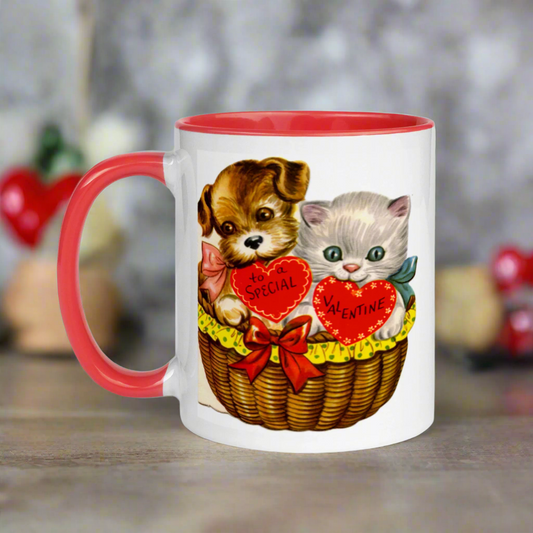 This ceramic glossy red lined mug features a midcentury retro Valentine's Day illustration of a puppy and kitten in a basket. The puppy is holding a heart that says To a Special and the Kitten's heart says Valentine.