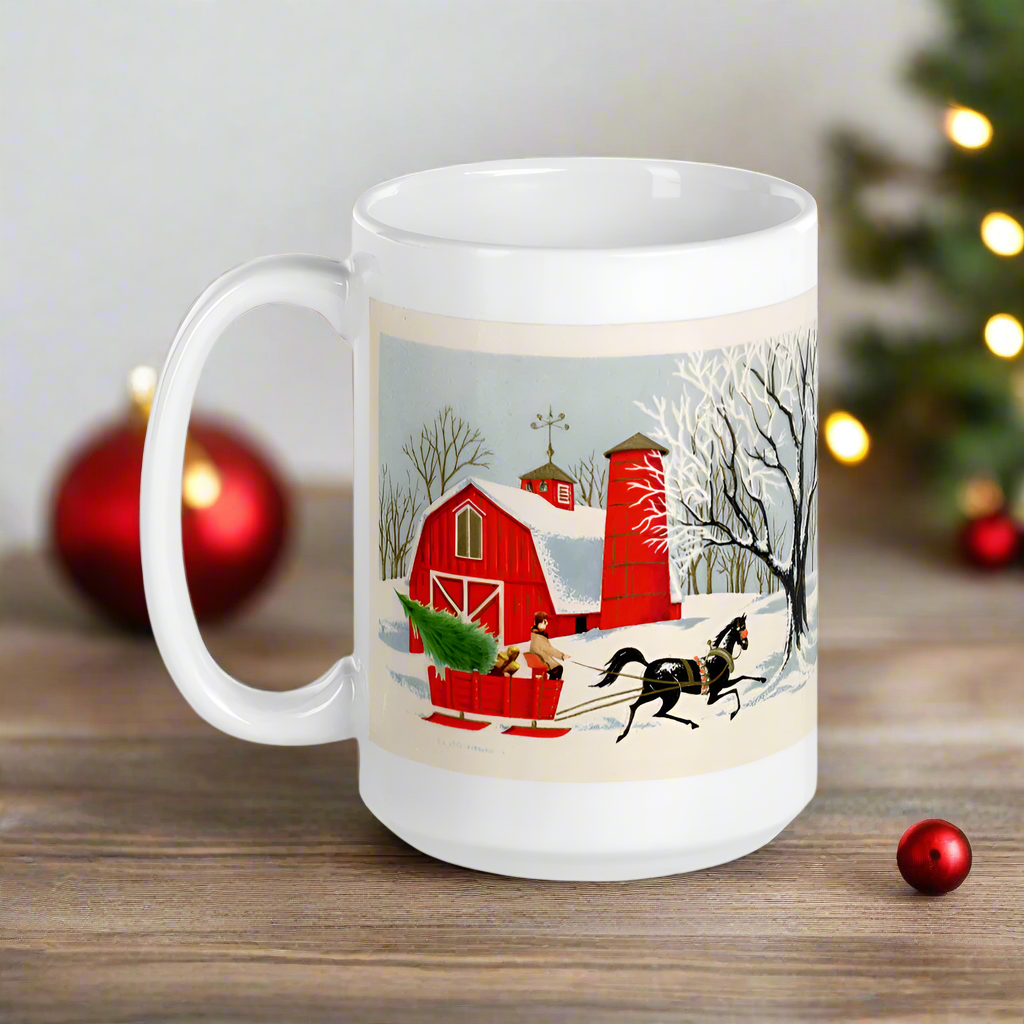 This ceramic glossy coffee mug features a vintage Christmas illustration of a snowy winter scene in the country. There is a red barn and a horse pulling a red sleigh with a Christmas tree.