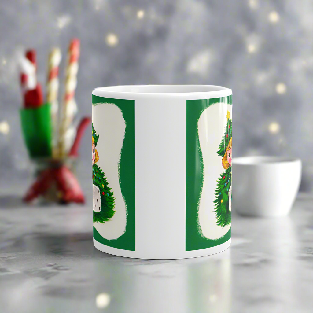 This ceramic glossy coffee mug features a blond girl wearing a christmas tree hat and coat. The hat is adorned with a yellow star on top. She is also wearing a white and green muff.