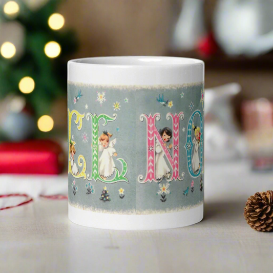 This ceramic glossy coffee mug features a vintage Midcentury Christmas illustration of pastel lettering that says Noel. There is an angel in each letter with snowflakes and flowers surrounding them.