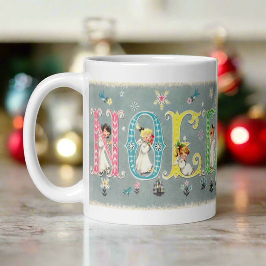 This ceramic glossy coffee mug features a vintage Midcentury Christmas illustration of pastel lettering that says Noel. There is an angel in each letter with snowflakes and flowers surrounding them.