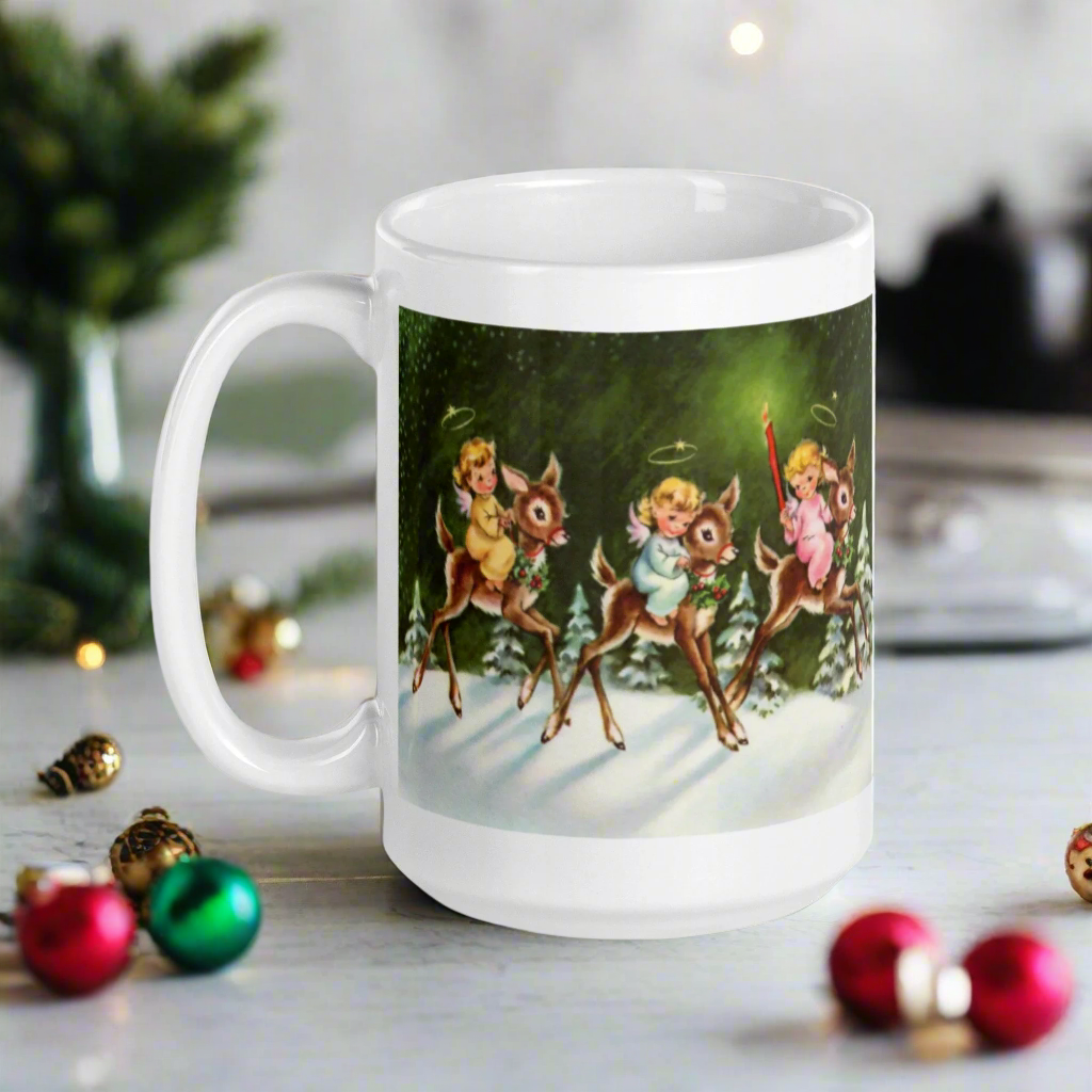 This ceramic glossy mug features three young angels riding reindeer in the snow.