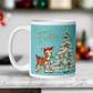 This glossy ceramic coffee mug features 
 Midcentury vintage artwork of an adorable reindeer with holly in her mouth, bunnies, and a Christmas Tree. There is gold lettering that says Season's Greetings and a blue felt background.