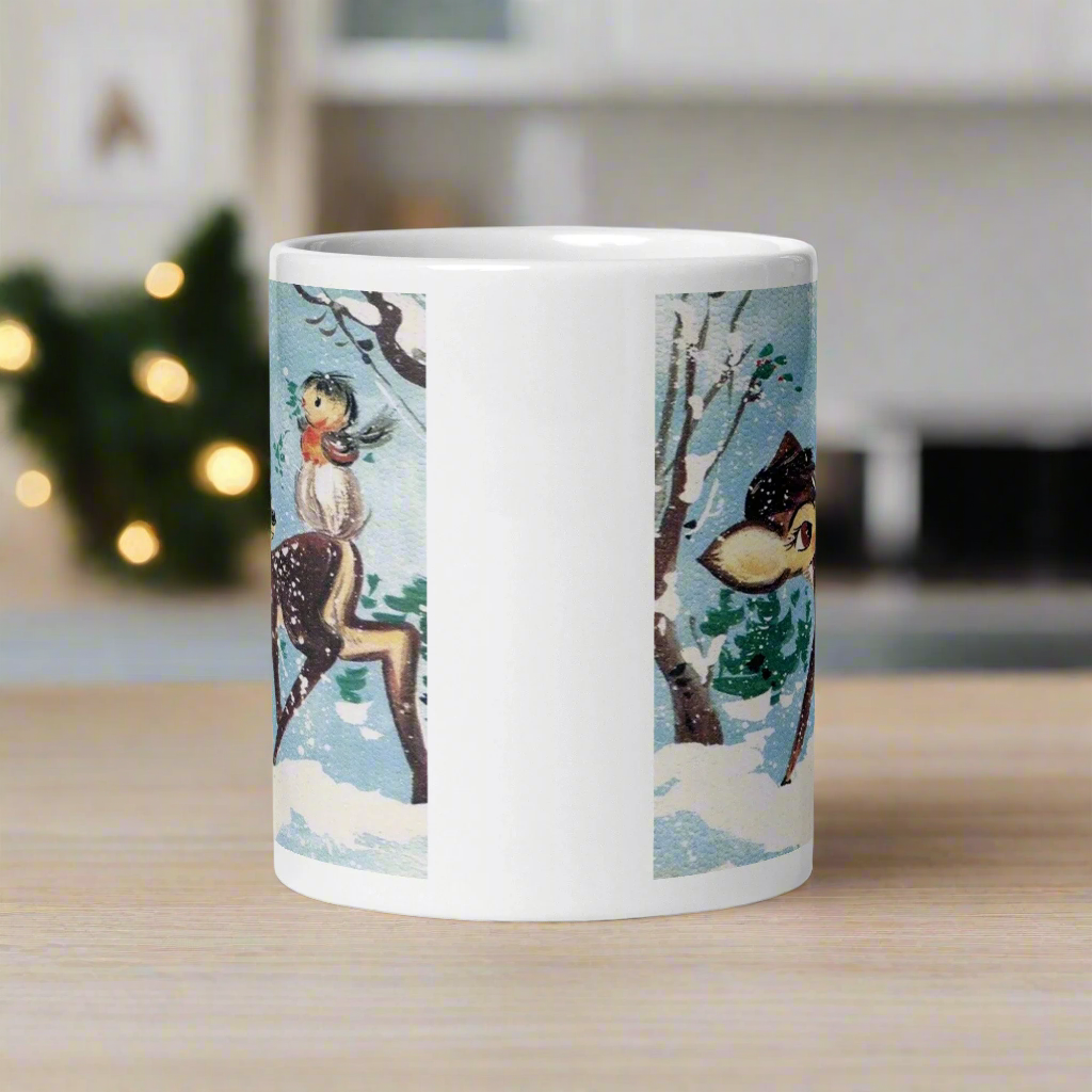 This glossy ceramic coffee cup features a retro woodland style Christmas winter illustration of a baby deer in the snow with a cute red and brown bird perched on her tail.