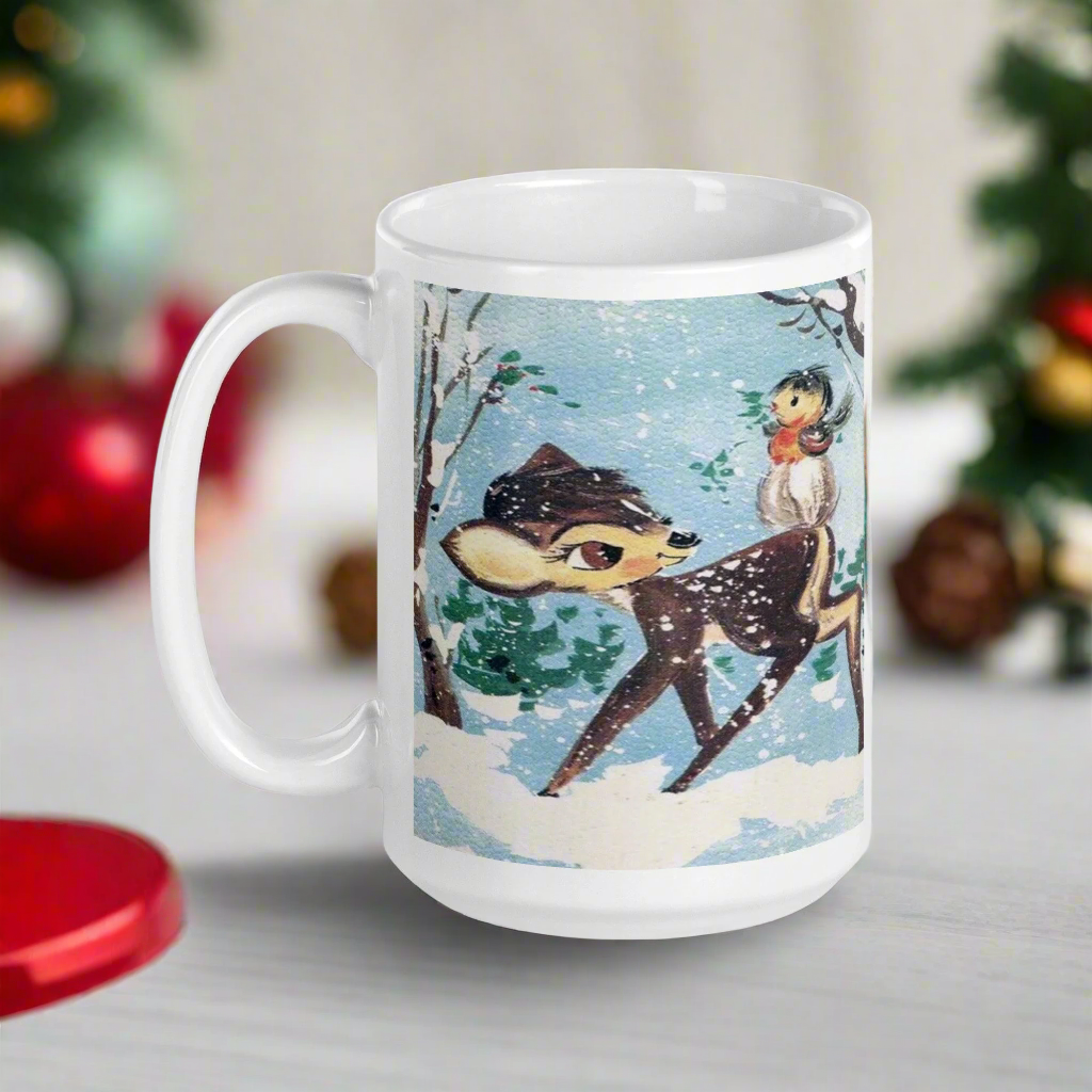 This glossy ceramic coffee cup features a retro woodland style Christmas winter illustration of a baby deer in the snow with a cute red and brown bird perched on her tail.