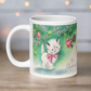 This ceramic glossy coffee mug features a midcentury vintage Christmas Illustration that says It's Christmas! There is an adorable white kitten wearing a pink bow underneath the christmas tree.