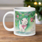 This ceramic glossy coffee mug features a midcentury vintage Christmas Illustration that says It's Christmas! There is an adorable white kitten wearing a pink bow underneath the christmas tree.